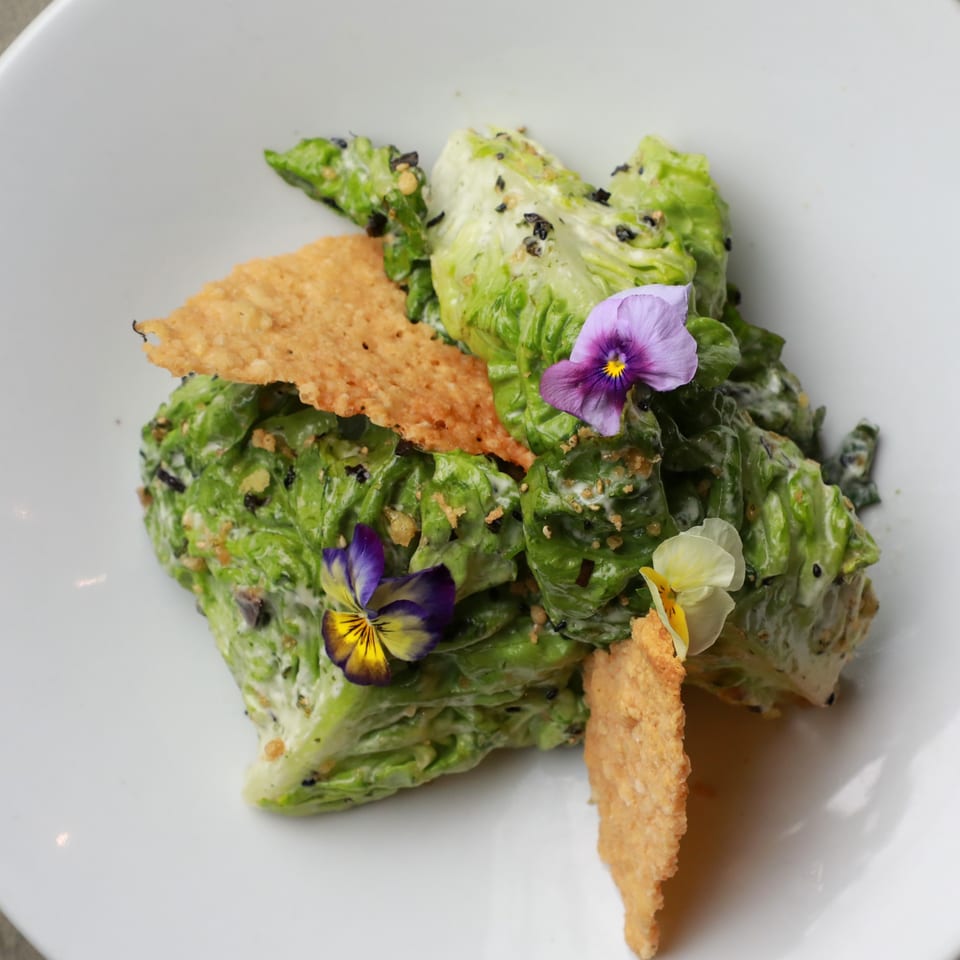 AnQi Bistro's Asian-fusion salad with lettuce, edible flowers, and crispy wonton chips.